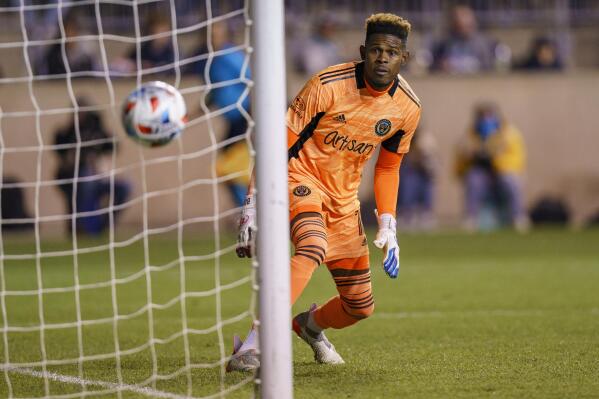 Philadelphia Union's Andre Blake watches as the show by Nashville SC's Hany Mukhtar goes in for a goal during the first half of an MLS playoff soccer match, Sunday, Nov. 28, 2021, in Chester, Pa. (AP Photo/Chris Szagola)