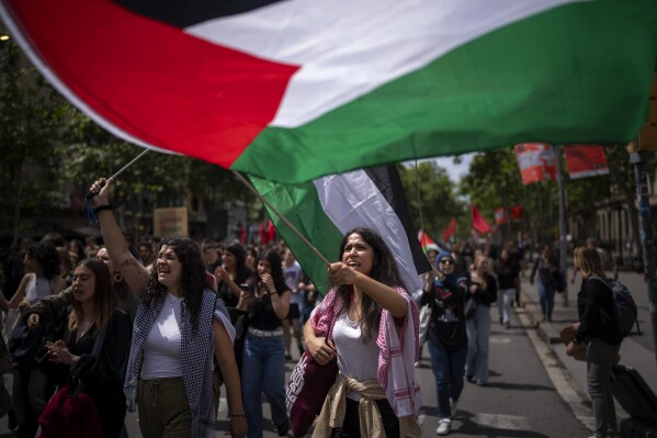 Students wave Palestinian flags as they march to show solidarity with Palestinians amid the ongoing war in Gaza and to commemorate the Nakba Day, Arabic for catastrophe, in Barcelona, Spain, Wednesday, May 15, 2024. (AP Photo/Emilio Morenatti)
