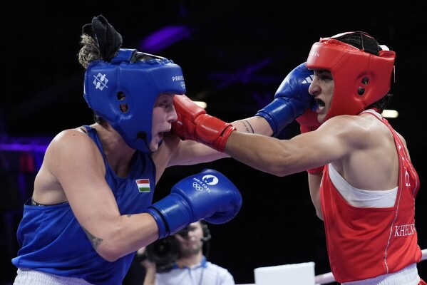 Algeria's Imane Khelif, right, fights Hungary's Anna Hamori in their women's 66kg quarterfinal boxing match at the 2024 Summer Olympics, Saturday, Aug. 3, 2024, in Paris, France. (AP Photo/John Locher)