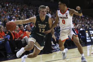 File-This Dec. 22, 2018, file photo shows William & Mary's guard Luke Loewe (12) driving around Virginia guard Kihei Clark (0) in the first half of an NCAA college basketball game, in Charlottesville, Va. Minnesota has made Loewe the latest piece of a major offseason roster revamp, picking up the graduate transfer from William & Mary. The Gophers announced the addition of Loewe on Monday, May 3, 2021. The 6-foot-4, 186-pound Loewe was a two-time All-Defensive Team pick in the Colonial Athletic Association and a second-team All-CAA selection in 2020-21. (AP Photo/Zack Wajsgras, File)