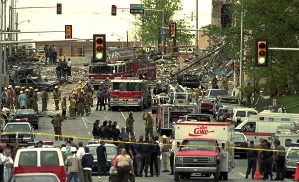 The streets surrounding the Alfred P. Murrah Federal Building in Oklahoma City are swamped with emergency vehicles and personnel on April 20, 1995, after a bomb tore through the building. (AP Photo/David J. Phillip, File)