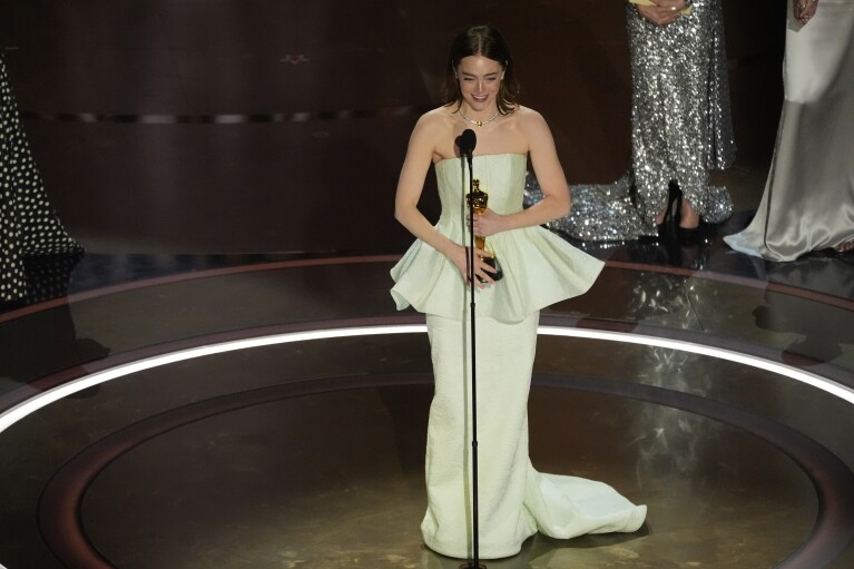 Emma Stone accepts the award for best performance by an actress in a leading role for 