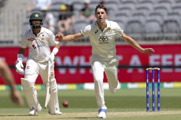 Australian bowler Pat Cummins reacts during play on the second day of the first cricket test between Australia and Pakistan in Perth, Australia, Friday, Dec. 15, 2023. (Richard Wainwright/AAP Image via AP)