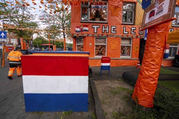 Orange tarp, orange bunting, and Dutch national flags decorate Marktweg street in The Hague, Netherlands, Thursday June 13, 2024, one day ahead of the start of the Euro 2024 Soccer Championship. The Marktweg is one of several streets in the Netherlands that get an all-encompassing orange facelift during European Championships and World Cups when the national team, known as Oranje after the Dutch royal family and the color of their shirts, are playing. (AP Photo/Peter Dejong)