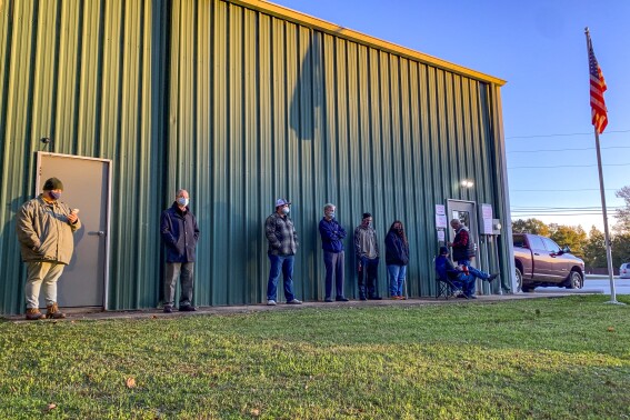 FILE - Voters wait for the polls to open to cast their ballots in the 2020 election at the Farmville Volunteer Fire Department, Nov. 3, 2020, in Auburn, Ala. Some 170 foundations, donors and advisors have signed on to a pledge started by the nonprofit Democracy Fund to make their grants earlier this Election Year. A small portion of the billions spent around the November election will go to nonprofits working to boost voter participation and usually, those funds come in right before Election Day. (AP Photo/Julie Bennett)
