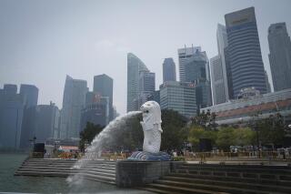 FILE - Merlion statue with the background of business district in Singapore, Saturday, Sept, 21, 2019. Singaporean man, Abdul Kahar Othman, 68, on death row for drug trafficking was hanged Wednesday, March 30, 2022, in the first execution in the city-state in over two years, rights activists said. (AP Photo/Vincent Thian, File)