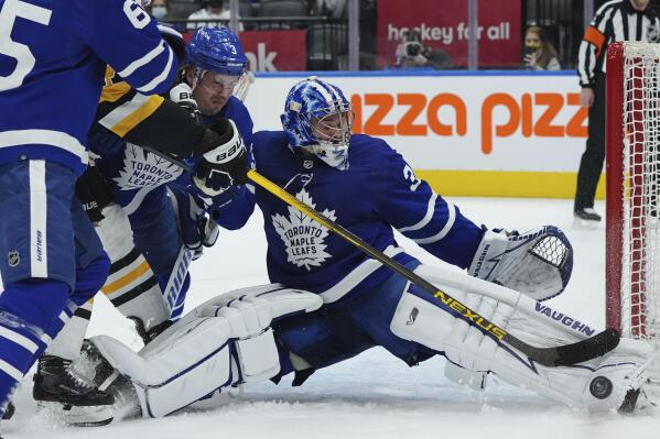 Toronto Maple Leafs goaltender Jack Campbell (36) makes a save on Pittsburgh Penguins forward Bryan Rust (17) as Maple Leafs defenseman Justin Holl (3) defends during the first period of an NHL hockey game Thursday, Feb. 17, 2022, in Toronto. (Nathan Denette/The Canadian Press via AP)