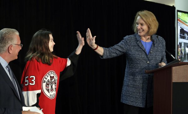 
              FILE - In this Oct. 8, 2018, file photo, Seattle Mayor Jenny Durkan, right, high-five's Washington Wild hockey team wing Jaina Goscinski, 11, as Tod Leiweke, CEO of NHL Seattle, looks on during a news conference in Seattle. The NHL Board of Governors is meeting, Tuesday, Dec. 4, 2018, in Sea Island, Ga., to give final approval to Seattle's bid to add the league's 32nd team. (AP Photo/Elaine Thompson, File)
            