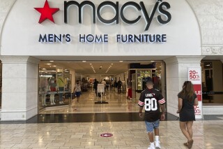 FILE - Shoppers walk into a Macy's department store Monday, Feb. 22, 2021, at Miami International Mall in Doral, Fla. Macy's reports earnings on Thursday, Nov. 16, 2023. (AP Photo/Wilfredo Lee, File)