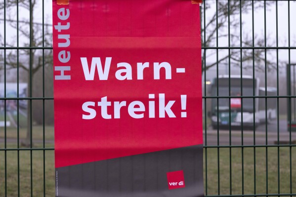 "Warning strike today" is written on posters at the entrance to the ViP depot (Verkehrsbetrieb Potsdam) in Potsdam, Germany, Friday March 1, 2024. Local buses, subway trains and trams ground to a halt in much of Germany Friday at the peak of a week of walkouts by employees demanding better working conditions. (Georg Moritz/dpa via AP)