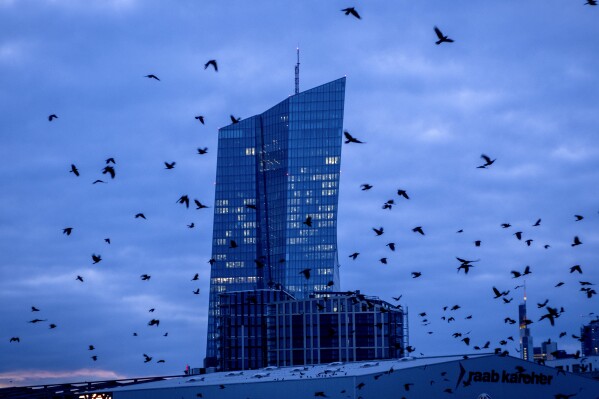 FILE - Crows fly in front of the European Central Bank in Frankfurt, Germany, on Feb. 26, 2024. The European Union's statistics agency Eurostat releases inflation figures for February on Friday March 1, 2024 amid speculation about when the European Central Bank will start cutting interest rates. (AP Photo/Michael Probst, File)