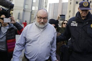 FILE - In this Nov. 20, 2015 file photo, convicted spy Jonathan Pollard leaves a federal courthouse in New York. Pollard, an American who served a 30-year sentence for spying for Israel, defended his actions in his first interview since arriving in Israel to a hero's welcome in December 2020, saying America had “stabbed Israel in the back” by withholding intelligence from its ally. In excerpts from the interview with the Israel Hayom daily published on Monday, March 22, 2021, Pollard describes his happiness at being a free man in Israel. (AP Photo/Mark Lennihan, File)