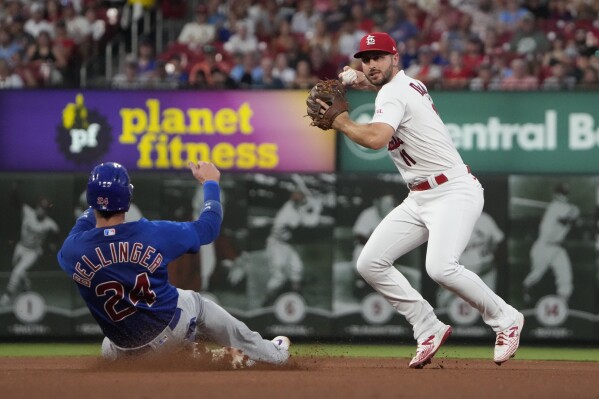 Chicago Cubs' Cody Bellinger (24) is out at second as St. Louis Cardinals shortstop Paul DeJong turns the double play during the fourth inning of a baseball game Friday, July 28, 2023, in St. Louis. The Cubs' Dansby Swanson was out at first. (AP Photo/Jeff Roberson)