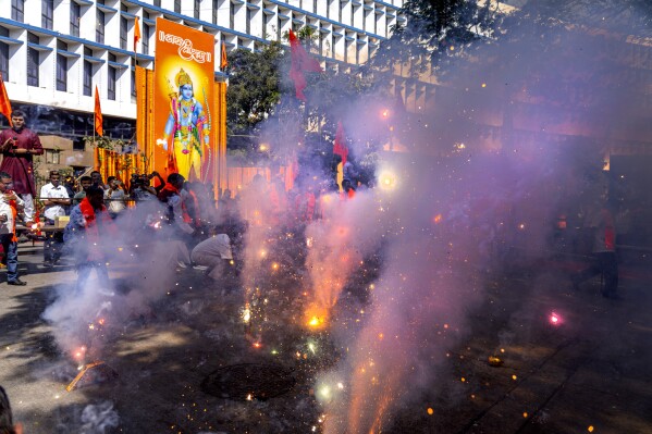 Supporters of India's ruling Bharatiya Janata Party light firecrackers in Mumbai, India, during the inauguration of a temple dedicated to the Hindu Lord Ram in Ayodhya, Monday, Jan. 22, 2024. Indian Prime Minister Narendra Modi on Monday opened a controversial Hindu temple built on the ruins of a historic mosque in the holy city of Ayodhya in a grand event that is expected to galvanize Hindu voters in upcoming elections. (AP Photo/Rafiq Maqbool)