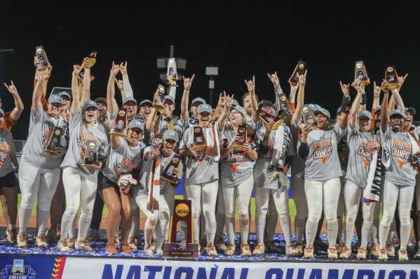 The Texas Longhorns softball team celebrates after defeating Texas Tech 10-4 to win the Women's College World Series championship in Oklahoma City, Friday, June 6, 2025. (AP Photo/Kyle Phillips)