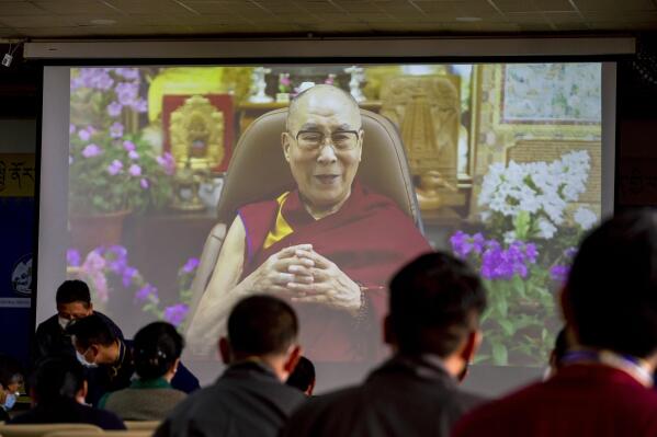 Exile Tibetan government officials watch a message from their spiritual leader the Dalai Lama on a screen during a ceremony to mark the 86th birthday of the Tibetan leader in Dharmsala, India, Tuesday, July 6, 2021. This year, due to the coronavirus pandemic, the celebrations were muted and behind closed doors. (AP Photo/Ashwini Bhatia)