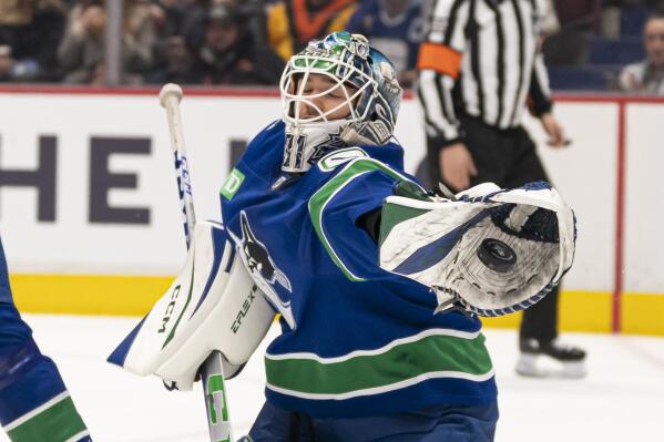 Vancouver Canucks goaltender Arturs Silovs reaches out to make a glove save against the Philadelphia Flyers during the first period of an NHL hockey game Saturday, Feb. 18, 2023, in Vancouver, British Columbia. (Rich Lam/The Canadian Press via AP)