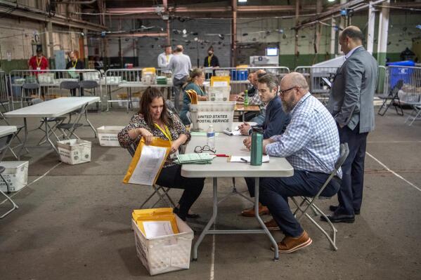 Allegheny County elections workers review provisional ballots with authorized representatives from Dave McCormick and Dr. Mehmet Oz's campaigns, Monday, May 23, 2022, on the North Side neighborhood of Pittsburgh, Pa. (Alexandra Wimley/Pittsburgh Post-Gazette via AP)