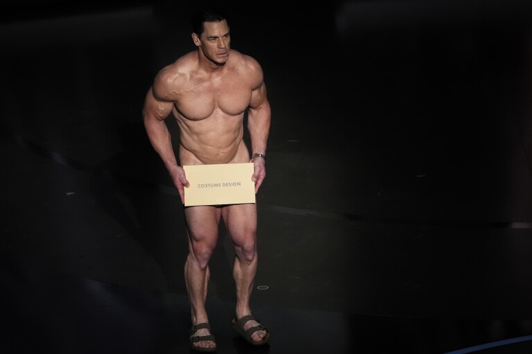 John Cena presents the award for best costume design during the Oscars on Sunday, March 10, 2024, at the Dolby Theatre in Los Angeles. (AP Photo/Chris Pizzello)