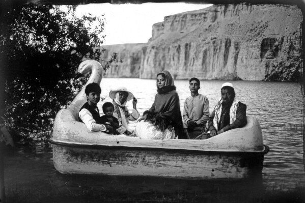 The Moradi family sits for a portrait on a small boat in Band-i-Mir lake, a tourist attraction in the Bamiyan Valley region in Afghanistan, on June 17, 2023. The family traveled there from far away Helmand for their summer vacation. This image was taken with a box camera, once ubiquitous in Afghanistan, but mostly a lost art form due to the Taliban's intolerance of photography and the advent of the digital age. (AP Photo/Rodrigo Abd)