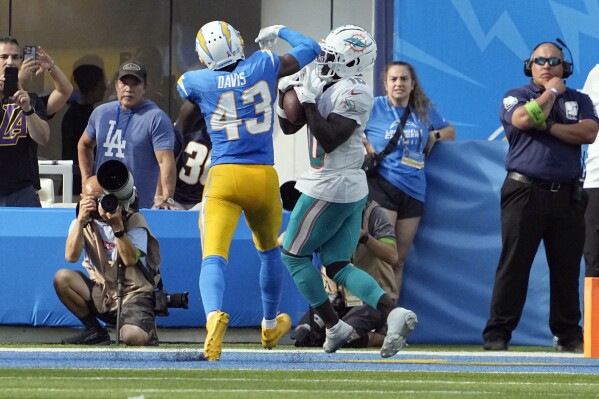 Miami Dolphins wide receiver Tyreek Hill, right, catches a touchdown in front of Los Angeles Chargers cornerback Michael Davis (43) during the second half of an NFL football game Sunday, Sept. 10, 2023, in Inglewood, Calif. (AP Photo/Mark J. Terrill)
