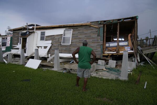 Randy Manuel surveys his and his mother's hurricane destroyed home in the aftermath of Hurricane Ida, Saturday, Sept. 4, 2021, in Dulac, La. (AP Photo/John Locher)