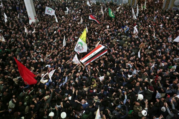 Mourners carry the coffins of Iran's Gen. Qassem Soleimani and Abu Mahdi al-Muhandis, deputy commander of Iran-backed militias at the Imam Ali shrine in Najaf, Iraq, Saturday, Jan. 4, 2020. Iran has vowed "harsh retaliation" for the U.S. airstrike near Baghdad's airport that killed Tehran's top general and the architect of its interventions across the Middle East, as tensions soared in the wake of the targeted killing. (AP Photo/Anmar Khalil)