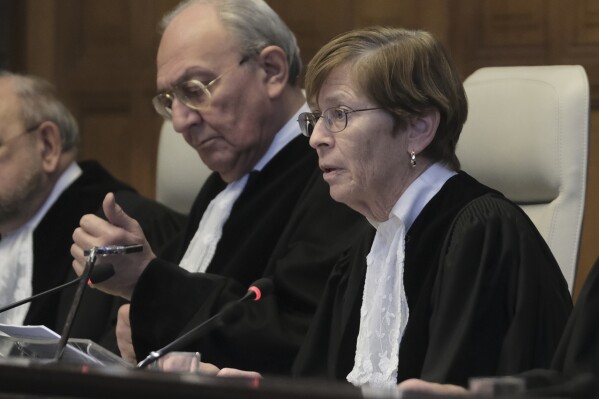 Presiding judge Joan Donoghue, right, opens the session at the International Court of Justice, or World Court, in The Hague, Netherlands, Friday, Jan. 26, 2024. Israel is set to hear whether the United Nations' top court will order it to end its military offensive in Gaza during a case filed by South Africa accusing Israel of genocide. (AP Photo/Patrick Post)