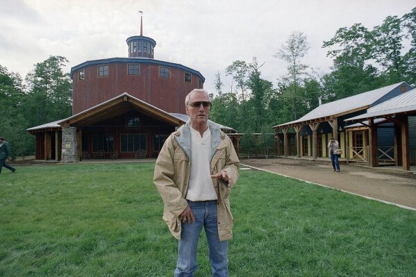 FILE - In this Thursday, June 9, 1988 file photo, Actor Paul Newman gestures as he arrives at "The Hole in the Wall" camp in Ashford, Conn. Newman is the camp founder and $7 million of profits from his "Newman's Own" Food Products, Inc. was contributed to help finance the camp. A fire on Friday evening, Feb. 12, 2021 destroyed four buildings at Paul Newman’s Hole in the Wall Gang Camp for seriously ill children in Connecticut. (AP Photo/Bob Child, File)