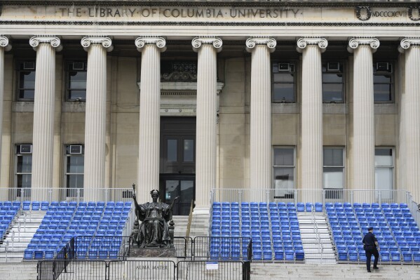 A New York City police officer walks past seating that was to be used for a large graduation ceremony at Columbia University in New York, Monday, May 6, 2024. The university says it is canceling its university-wide commencement ceremony following weeks of pro-Palestinian protests. Smaller school-based ceremonies are still on for this week and next. (AP Photo/Seth Wenig)