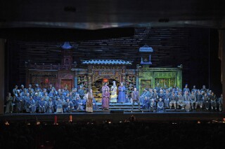 In this photo provided by the Metropolitan Opera, the cast performs during Act 1 of Puccini's “Turandot” on Wednesday, March 20, 2024, at the Metropolitan Opera in New York. The Met was forced to stage a semi-staged performance of the show after a stage elevator jammed. (Karen Almond/Metropolitan Opera via AP)