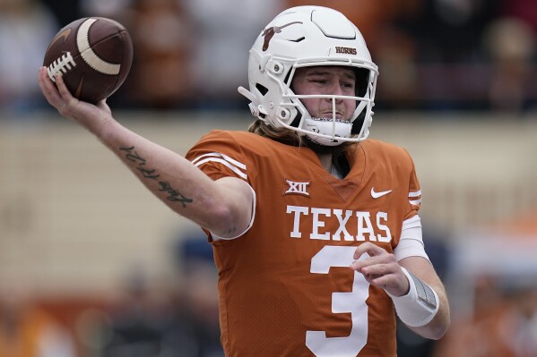 FILE - Texas quarterback Quinn Ewers looks to pass against Baylor during the first half of an NCAA college football game in Austin, Texas, Nov. 25, 2022. Texas opens their season at home against Rice on Sept. 2. (AP Photo/Eric Gay, File)