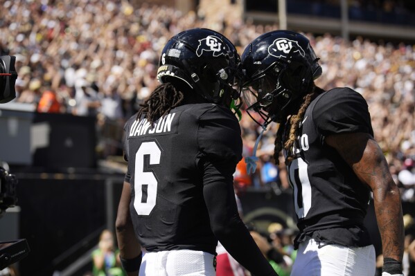 Colorado wide receiver Tar'Varish Dawson, left, is congratulated by wide receiver Xavier Weaver after scoring a touchdown in the second half of an NCAA college football game against Nebraska Saturday, Sept. 9, 2023, in Boulder, Colo. (AP Photo/David Zalubowski)