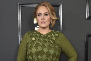 FILE - Adele arrives at the 59th annual Grammy Awards on Feb. 12, 2017, in Los Angeles. The singer will share custody of her 8-year-old son and won’t be paying child support to her now-ex-husband Simon Konecki. The couple separated in August of 2019, and Adele filed for divorce the following month. A Los Angeles judge finalized the divorce last week. (Photo by Jordan Strauss/Invision/AP, File)