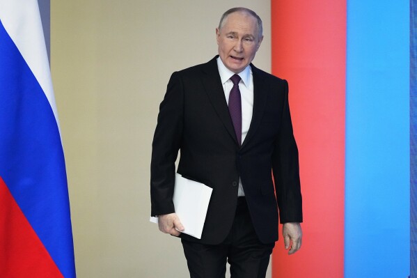 Russian President Vladimir Putin enters a hall to deliver his state-of-the-nation address in Moscow, Russia, Thursday, Feb. 29, 2024. (AP Photo/Alexander Zemlianichenko)