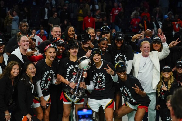 The Las Vegas Aces celebrate with the trophy after Game 4 of a WNBA basketball final playoff series against the New York Liberty Wednesday, Oct. 18, 2023, in New York. The Aces won 70-69. (AP Photo/Frank Franklin II)