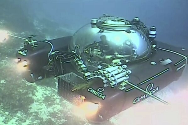 
              An image taken from video issued by Nekton shows a submersible from the vessel the Ocean Zephyr during a descent into the Indian Ocean off Alphonse Atoll near the Seychelles, Tuesday March 12, 2019. Members of the British-led Nekton research team boarded two submersible vessels and descended into the waters off the Seychelles on Tuesday, marking a defining moment in their mission to document changes to the Indian Ocean. The submersibles will be battling strong undersea currents and potentially challenging weather conditions as they survey the side of an undersea mountain off Alphonse Atoll. (Nekton via AP)
            