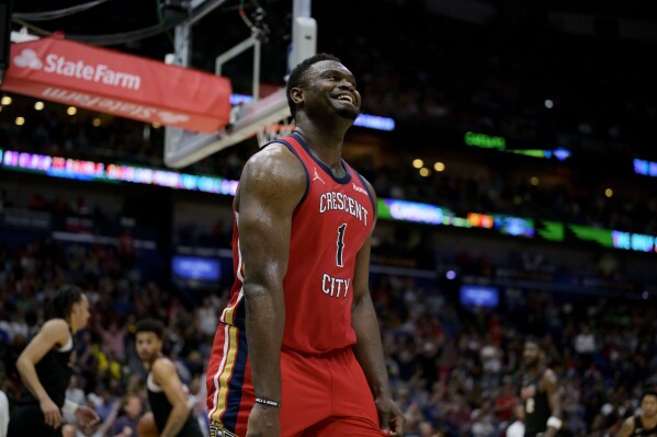 New Orleans Pelicans forward Zion Williamson (1) smiles after making a basket against the Portland Trail Blazers at the end of the first half of an NBA basketball game in New Orleans, Saturday, March 16, 2024. (AP Photo/Matthew Hinton)