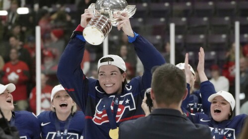 FILE - United States forward Hilary Knight, center, holds the cup as she celebrates with teammates after defeating Canada in the gold medal game at the women's world hockey championships in Brampton, Ontario, April 16, 2023. Patience remains the operative word from United States star Knight on the Professional Women’s Hockey Players’ Association’s long-awaited bid to launch its own pro league. (Nathan Denette/The Canadian Press via AP, File)