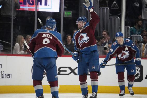 Colorado Avalanche right wing Valeri Nichushkin, center, celebrates after scoring a goal with defenseman Cale Makar, left, and center Nathan MacKinnon in the second period of an NHL hockey game against the San Jose Sharks Tuesday, March 7, 2023, in Denver. (AP Photo/David Zalubowski)