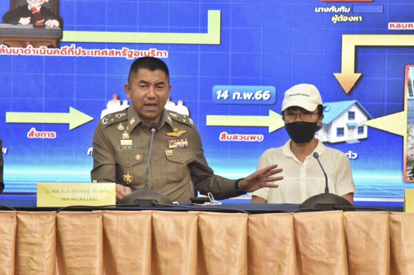 FILE - Deputy National Police Chief Surachet Hakpal, left, talks to reporters with Tubtim "Sue" Howson, 57, during press conference at police headquarter in Bangkok, Thailand, on Feb. 15, 2023. Police belonging to the cybercrime division on Monday, Sept. 25, searched the Bangkok residence of Surachate Hakparn __ who is seen as a contender for the police agency's top job - allegedly in connection with suspicion that several of his subordinates had corrupt links to illegal online gambling operations.(Royal Thai Police via AP, File)