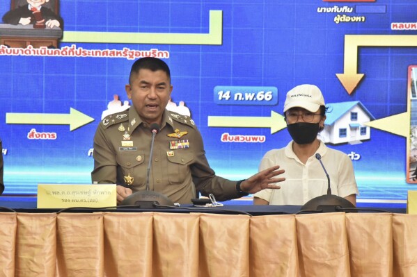 FILE - Deputy National Police Chief Surachet Hakpal, left, talks to reporters with Tubtim 