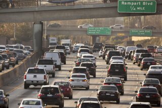 FILE - This Dec. 12, 2018, file photo shows traffic on the Hollywood Freeway in Los Angeles. The Trump administration is rolling back tough Obama-era mileage standards and gutting one of the United States' biggest efforts to slow climate change. The administration released its relaxed mileage rules Tuesday. (AP Photo/Damian Dovarganes, File)