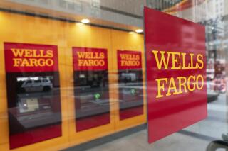 FILE - This Jan. 13, 2021 file photo shows a Wells Fargo office in New York. Wells Fargo & Co. reports earnings on Friday, April 24, 2023. (AP Photo/Mark Lennihan, File)