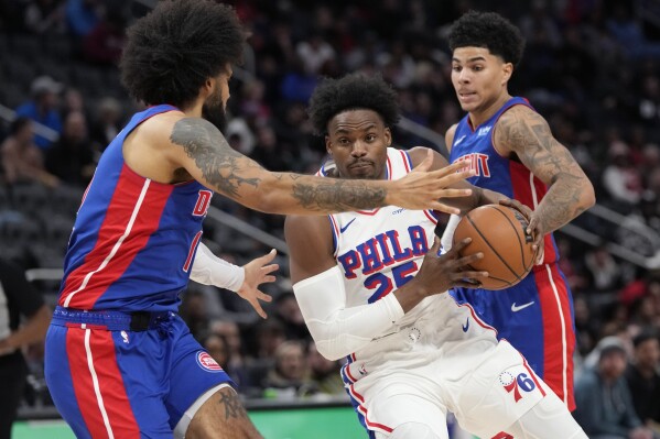 Philadelphia 76ers forward Danuel House Jr. (25) is defended b Detroit Pistons forward Isaiah Livers during the second half of an NBA basketball game, Wednesday, Dec. 13, 2023, in Detroit. (AP Photo/Carlos Osorio)