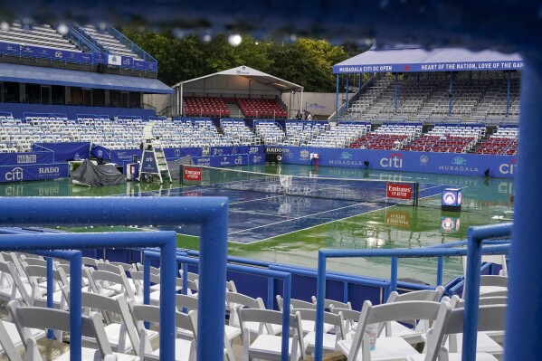 The stadium is empty as rain falls to delay the the men's singles final of the DC Open tennis tournament between Daniel Evans, of Britain, and Tallon Griekspoor, of the Netherlands, Sunday, Aug. 6, 2023, in Washington. (AP Photo/Alex Brandon)
