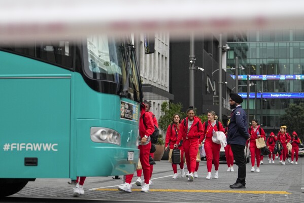 Members of the Philippines Women's World Cup team walk to their team bus following a shooting near their hotel in the central business district in Auckland, New Zealand, Thursday, July 20, 2023. A gunman killed two people before he died Thursday at a construction site in Auckland, as the nation prepared to host games in the FIFA Women's World Cup soccer tournament.(AP Photo/Abbie Parr)
