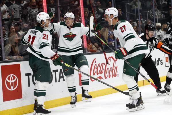 Minnesota Wild forwards Nico Sturm, center, celebrates his goal with Brandon Duhaime, left, and Nick Bjugstad during the second period of an NHL hockey game Saturday, Oct. 16, 2021, in Los Angeles. (AP Photo/Ringo H.W. Chiu)