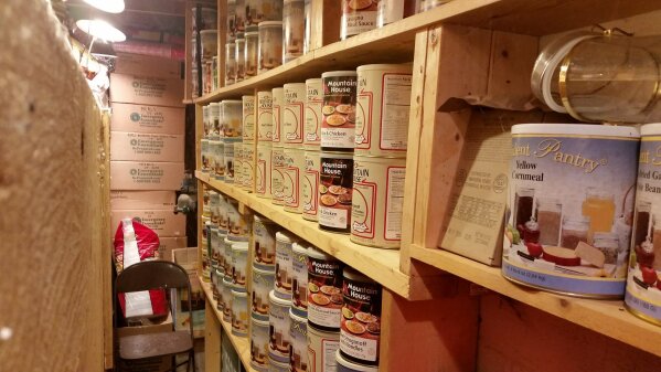 In this undated photo provided by Paul Buescher, canned food rests on shelves in a barn near Garretsville, Ohio. The food can be used by 32 members of a group in northeastern Ohio that shares a farm packed with enough canned and dehydrated food and water to last for years. For those in the often-mocked "prepper" community, this is quickly becoming their "I told you so" moment, as panic buying has cleared store shelves across the U.S. amid growing fears that the new coronavirus will force many Americans to self-quarantine for weeks in their homes. (Paul Buescher via AP)