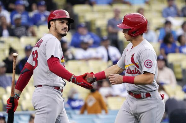 St. Louis Cardinals' Tommy Edman, right, is congratulated by Nolan Arenado after scoring on a ground rule double by Paul Goldschmidt during the first inning of a baseball game against the Los Angeles Dodgers Tuesday, June 1, 2021, in Los Angeles. (AP Photo/Mark J. Terrill)